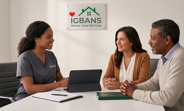 An IHCS coordinator meeting with a couple at the office, the Igbans Home Care Services sign on the wall behind them